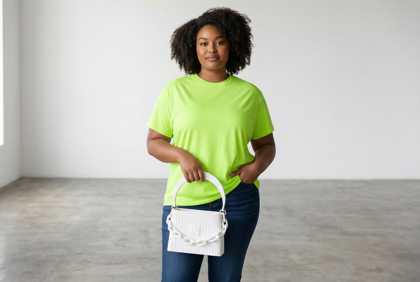 Model trägt HAKO Handtasche in Weiß mit Ketten-Detail, moderner Lifestyle-Look im minimalistischen Studio